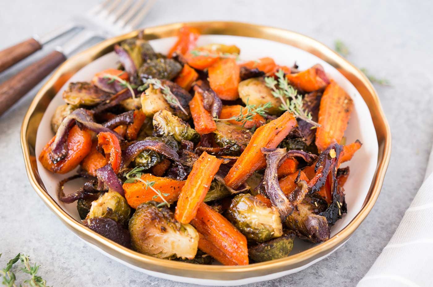 roasted brussel sprouts, carrots, and onions in a bowl serve for thanksgiving table