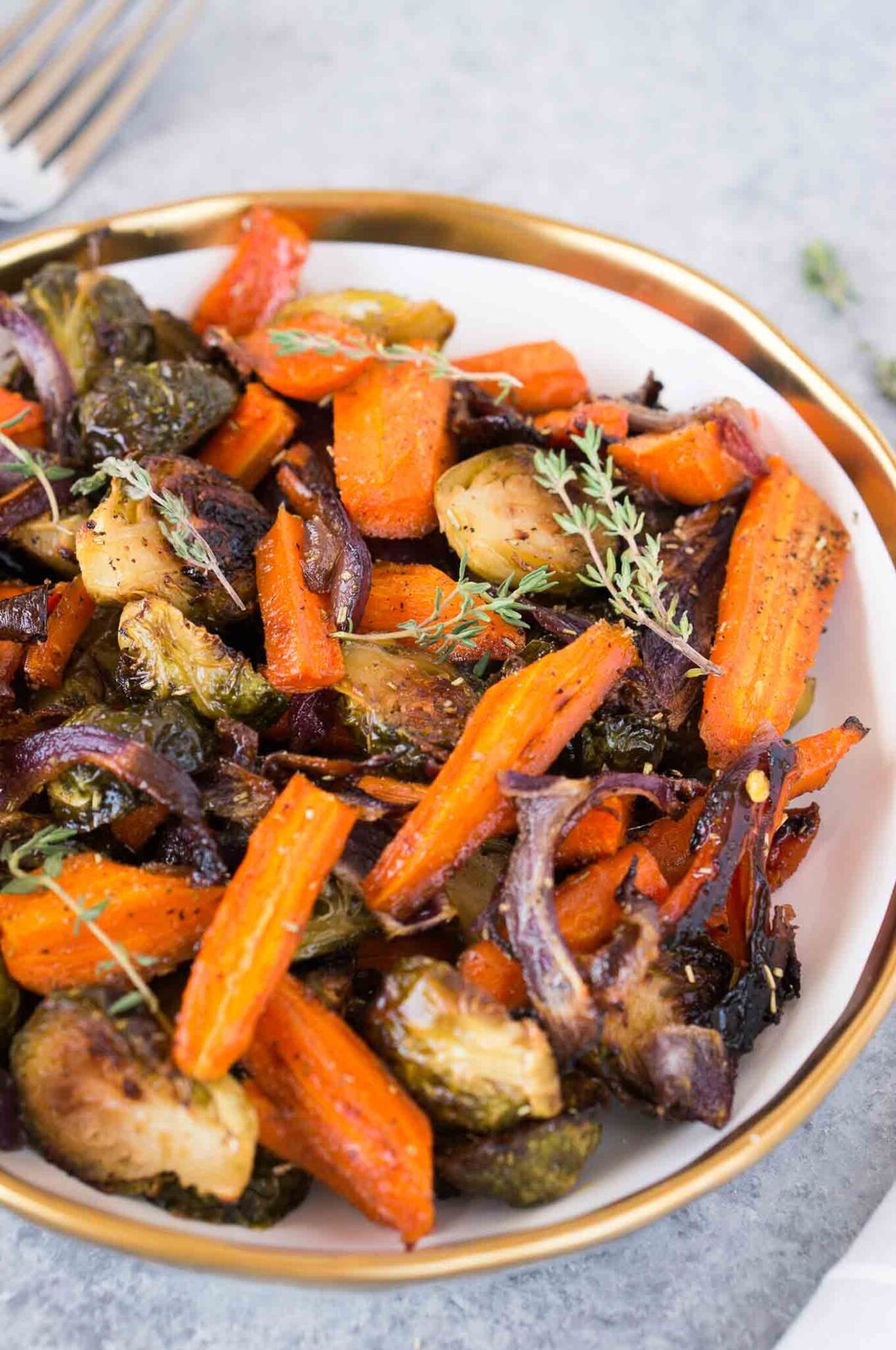roasted Brussels spouts onions and carrots in a bowl