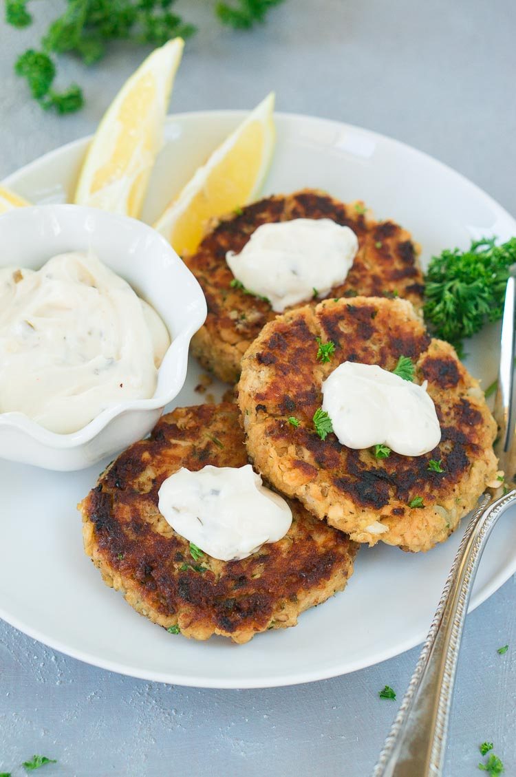patties served on a plate with tartar sauce on top