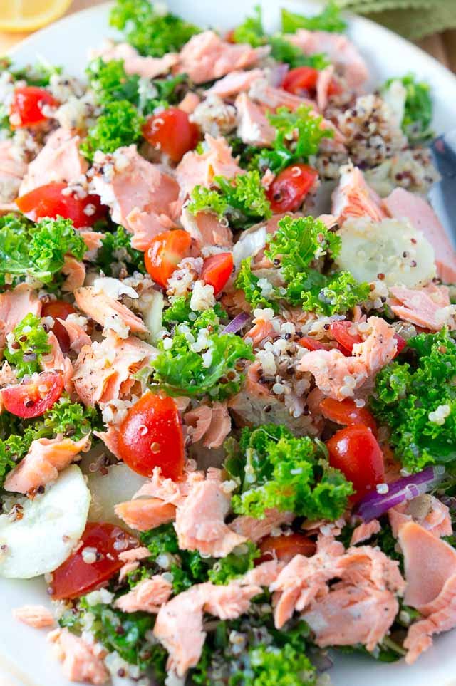 Delicious Salmon Quinoa and Kale Salad that is bursting with flavor and healthy ingredients. Perfect weeknight dinner - 15 min. to cook and easy prep work.