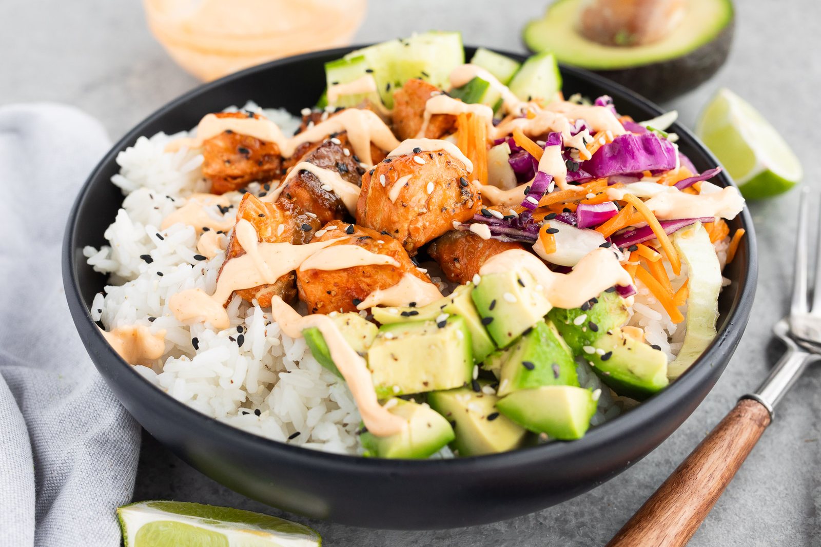 salmon with rice and vegetables in a bowl