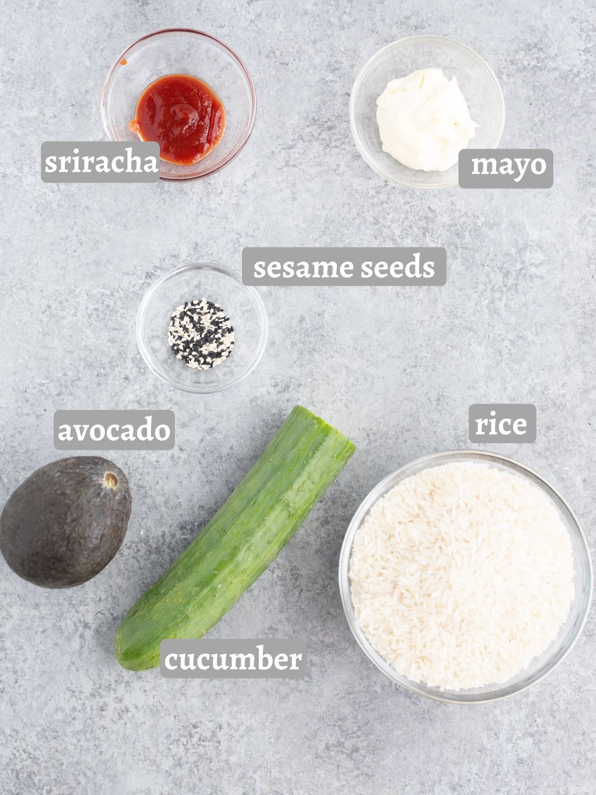 ingredients for making a bowl with rice cucumber avocado and salmon