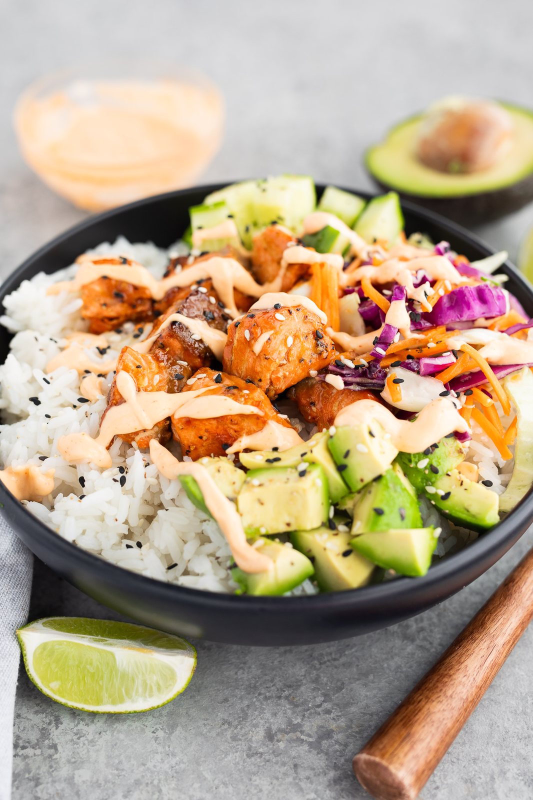 salmon rice bowl recipe served with cucumbers and avocados