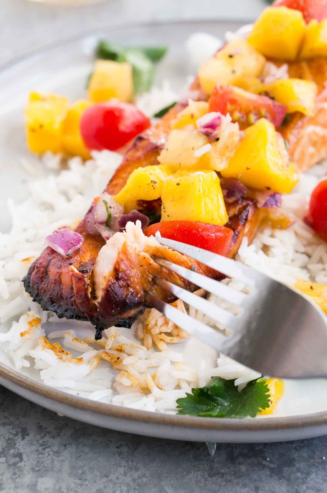 a bite of salmon with fruit salsa