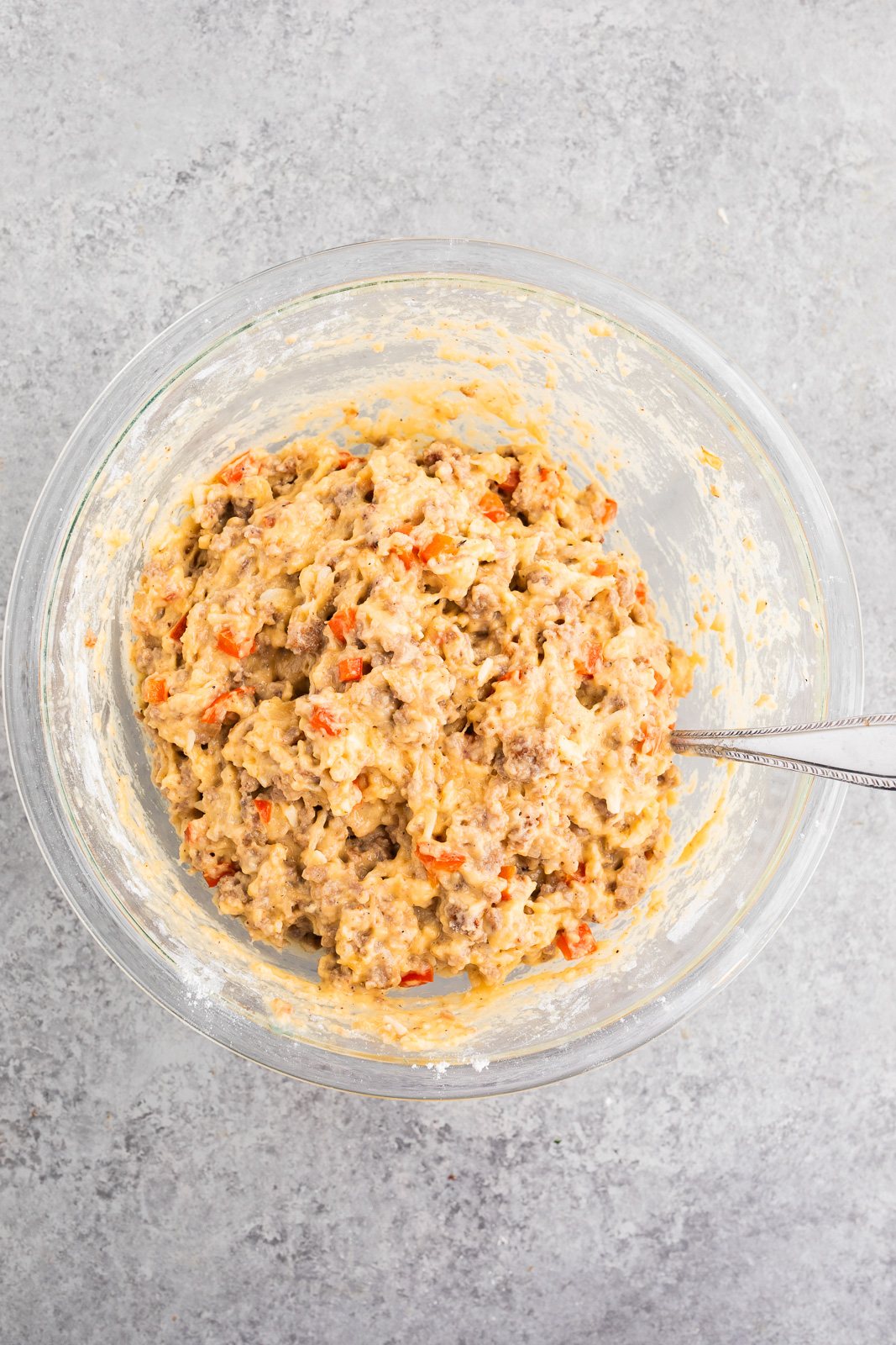 Thick biscuit dough mixed with sausage, eggs, cheese, and peppers for make-ahead breakfast
