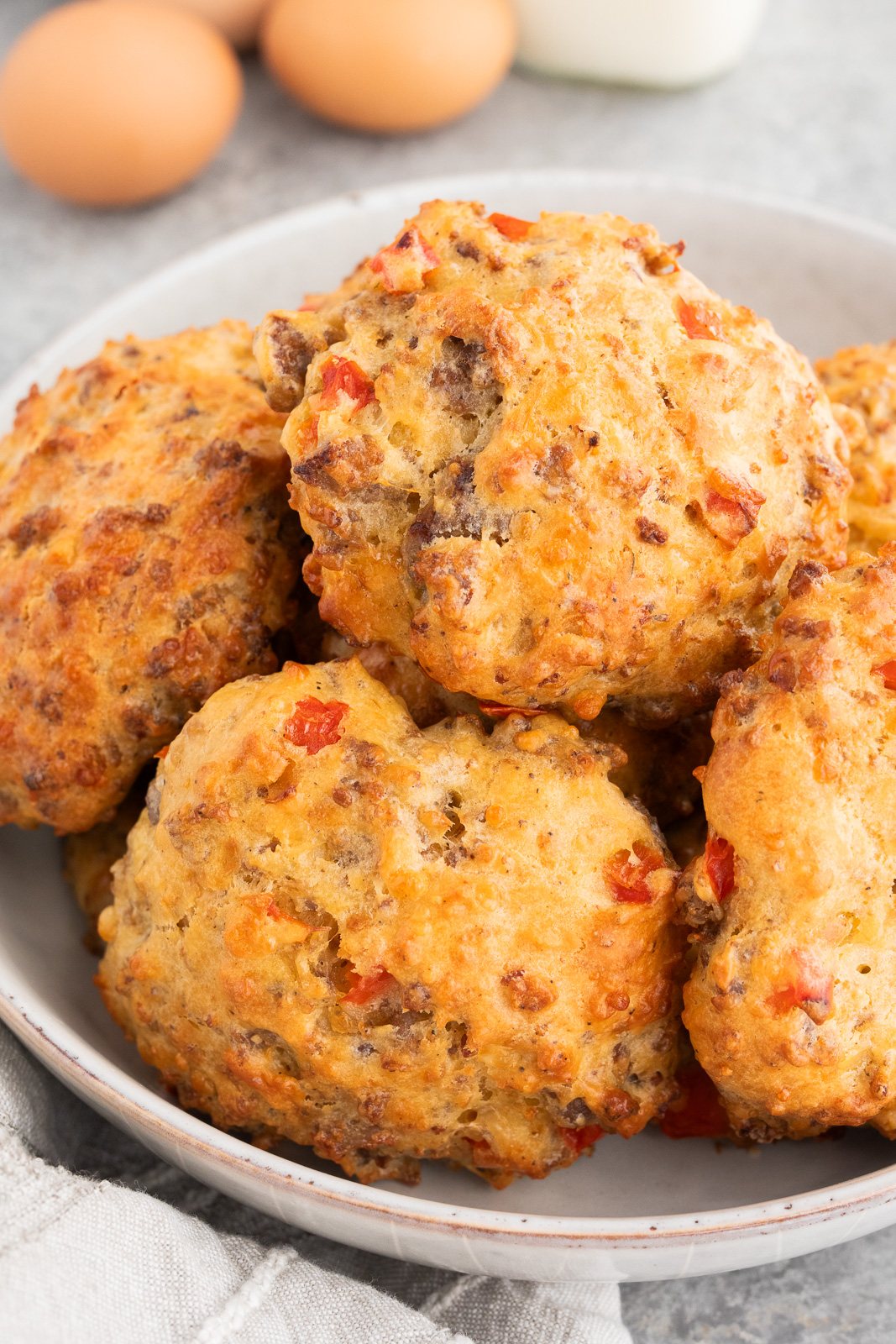 Close-up of sausage egg breakfast biscuits with cheddar cheese in a serving bowl