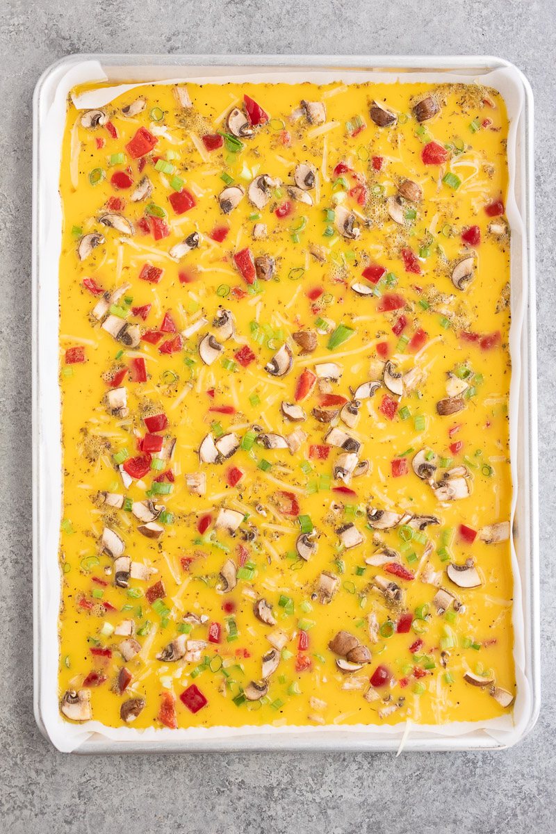eggs and veggies on a baking sheet
