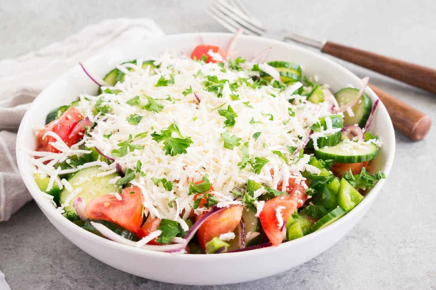 shopska salad in a white bowl