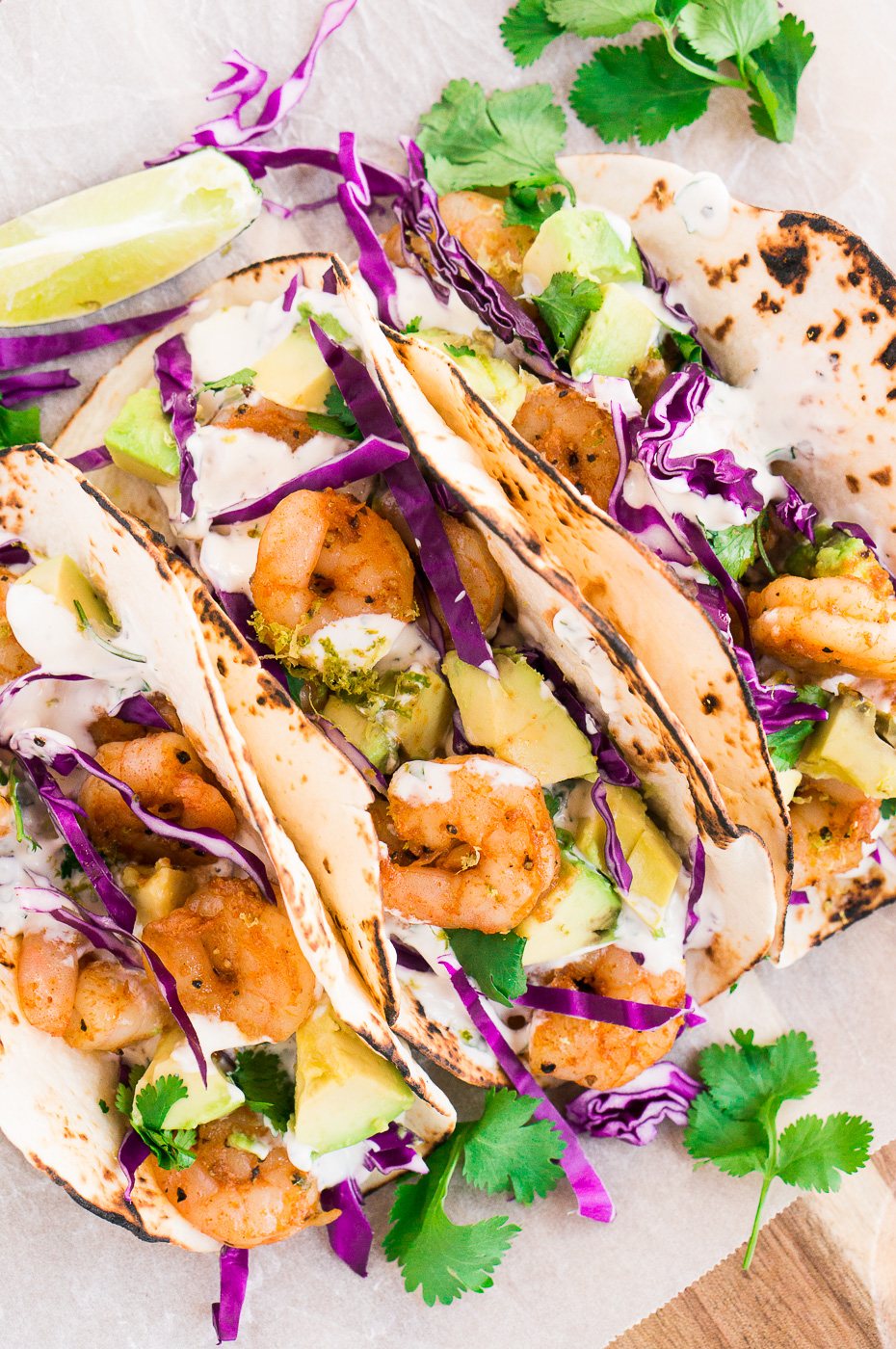 shrimp tacos recipe with cilantro lime sauce on a board