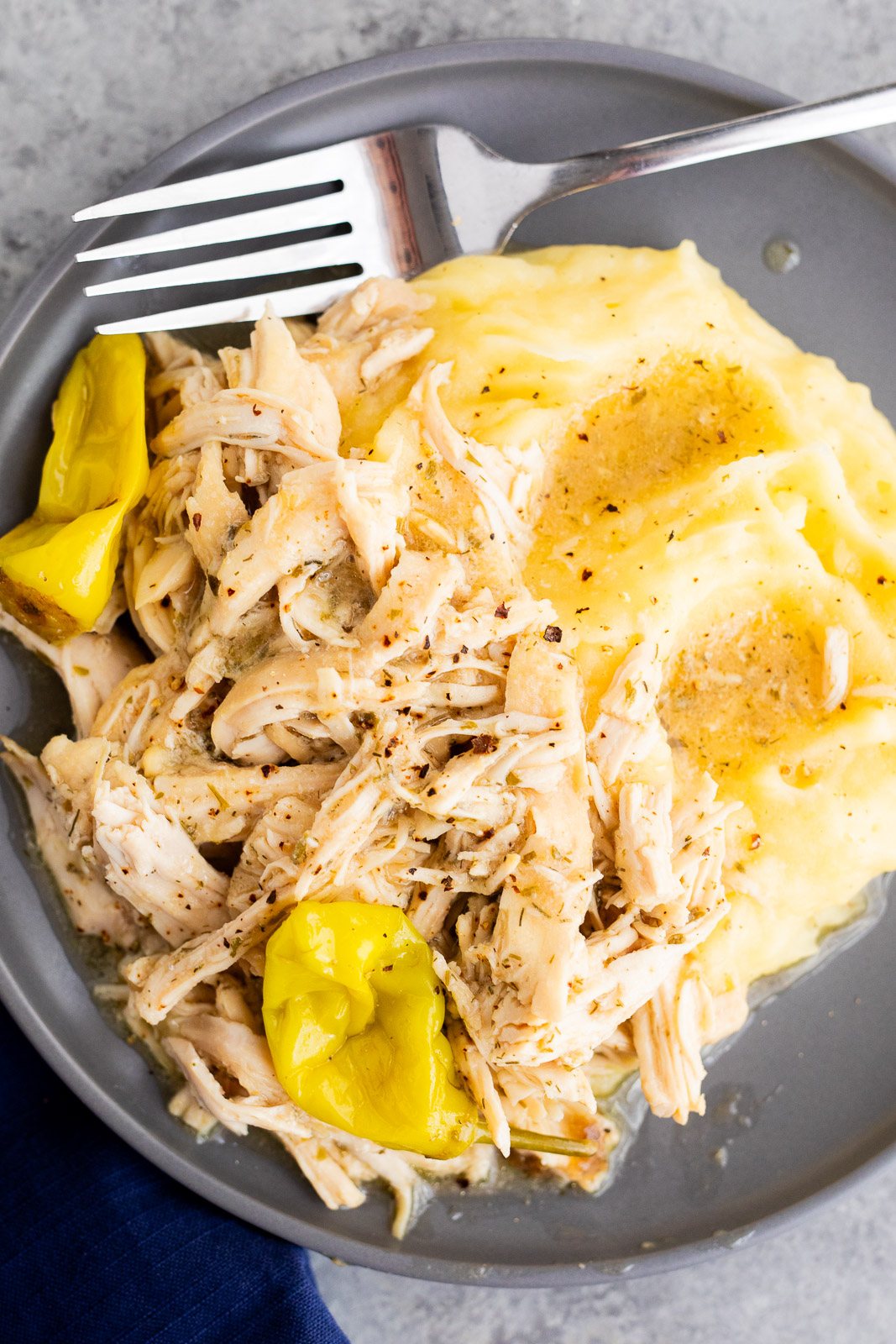 Slow Cooker Mississippi Chicken served over mashed potatoes