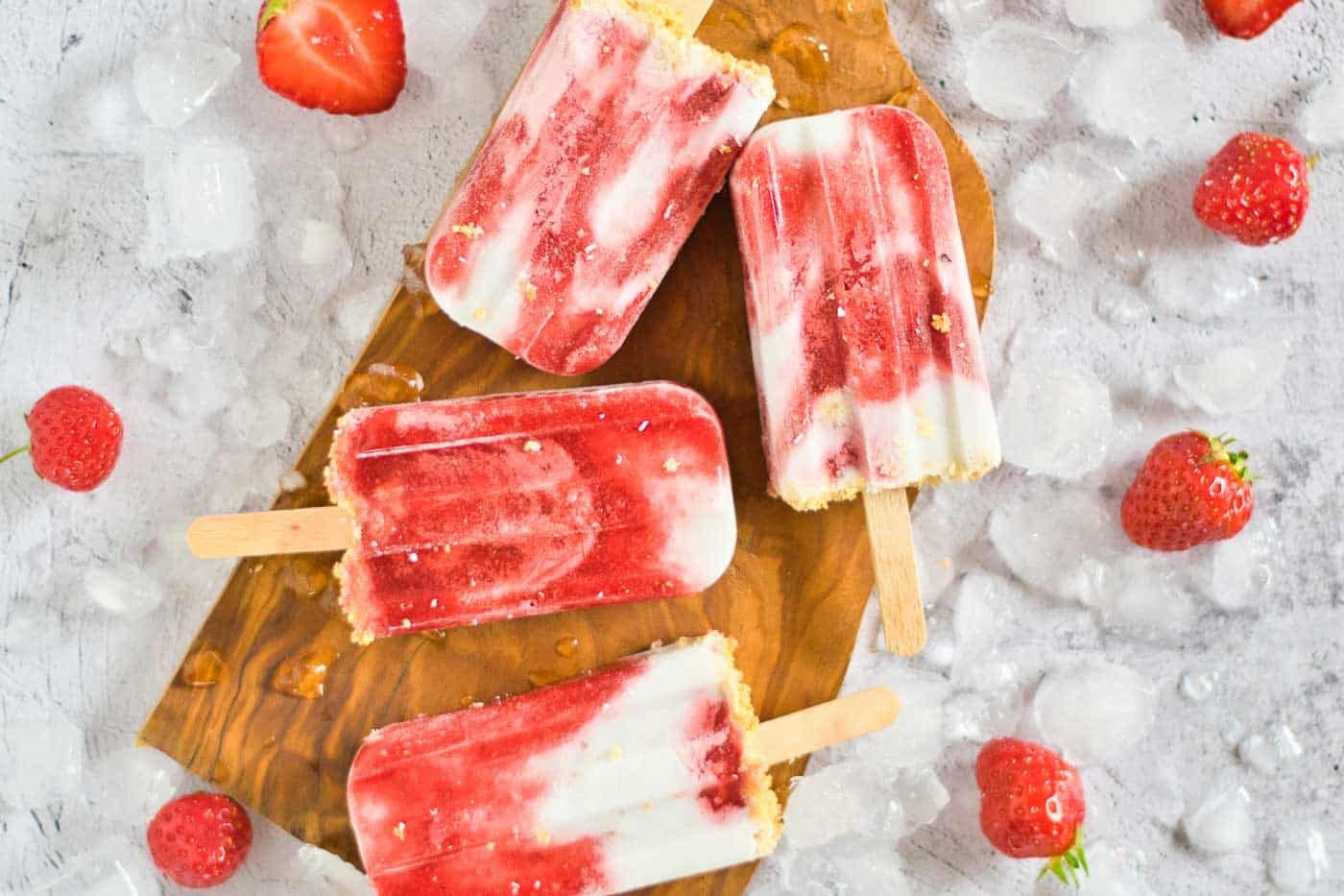 close up image of popsicles with strawberries