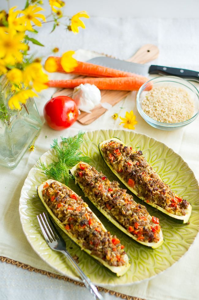 Stuffed Zucchini Boats served on a plate with a sprig of dill