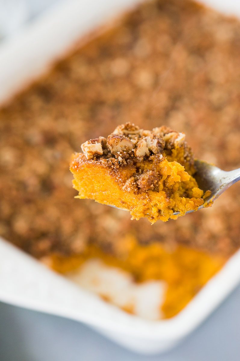 scooping sweet potato casserole with a spoon