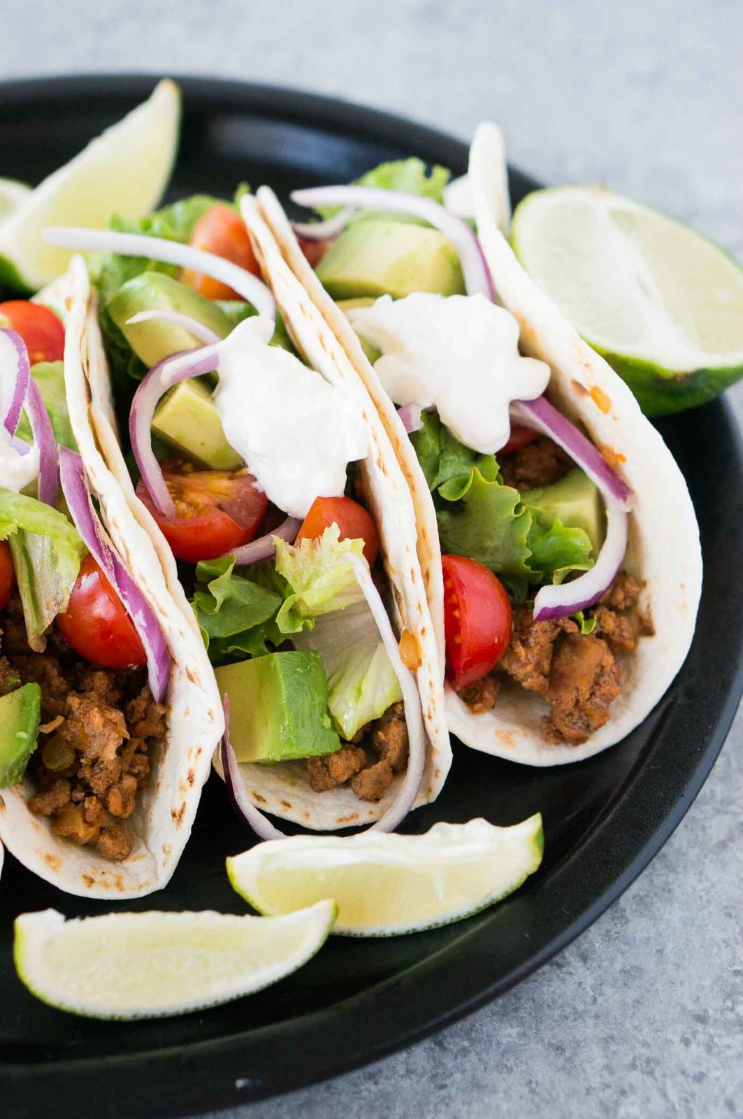close up image of mexican ground beef tacos on a plate