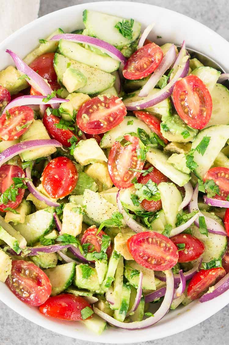 Tomato cucumber avocado salad in a bowl