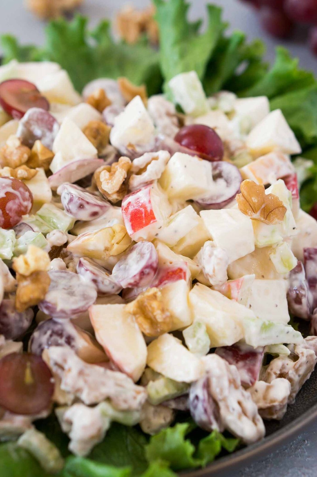 close up image of waldorf salad on green leaf lettuce