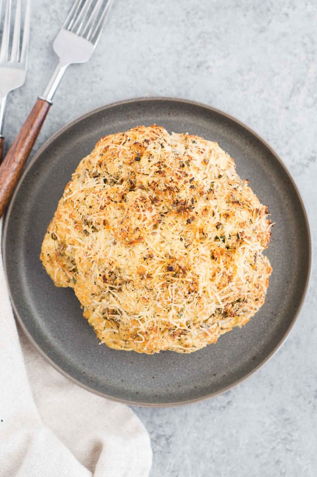 baked whole cauliflower on a plate