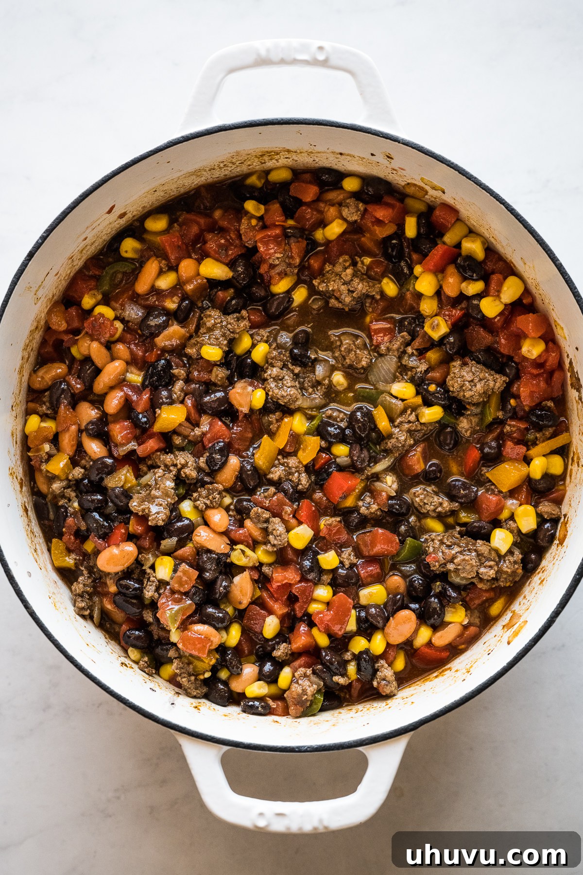 Taco soup fully mixed and simmering in a large pot, showing the rich colors and textures.