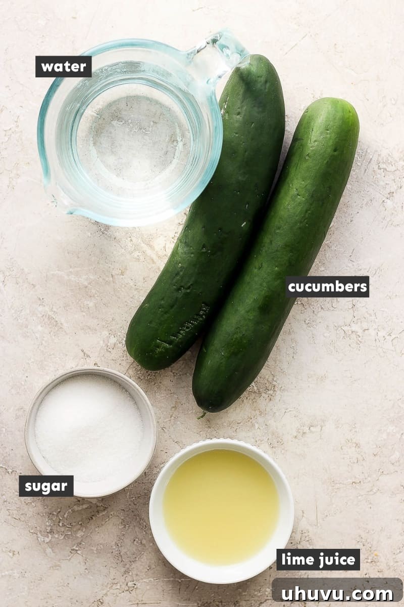 Fresh ingredients for Agua de Pepino, including whole cucumbers, limes, and granulated sugar, neatly arranged on a rustic wooden table.