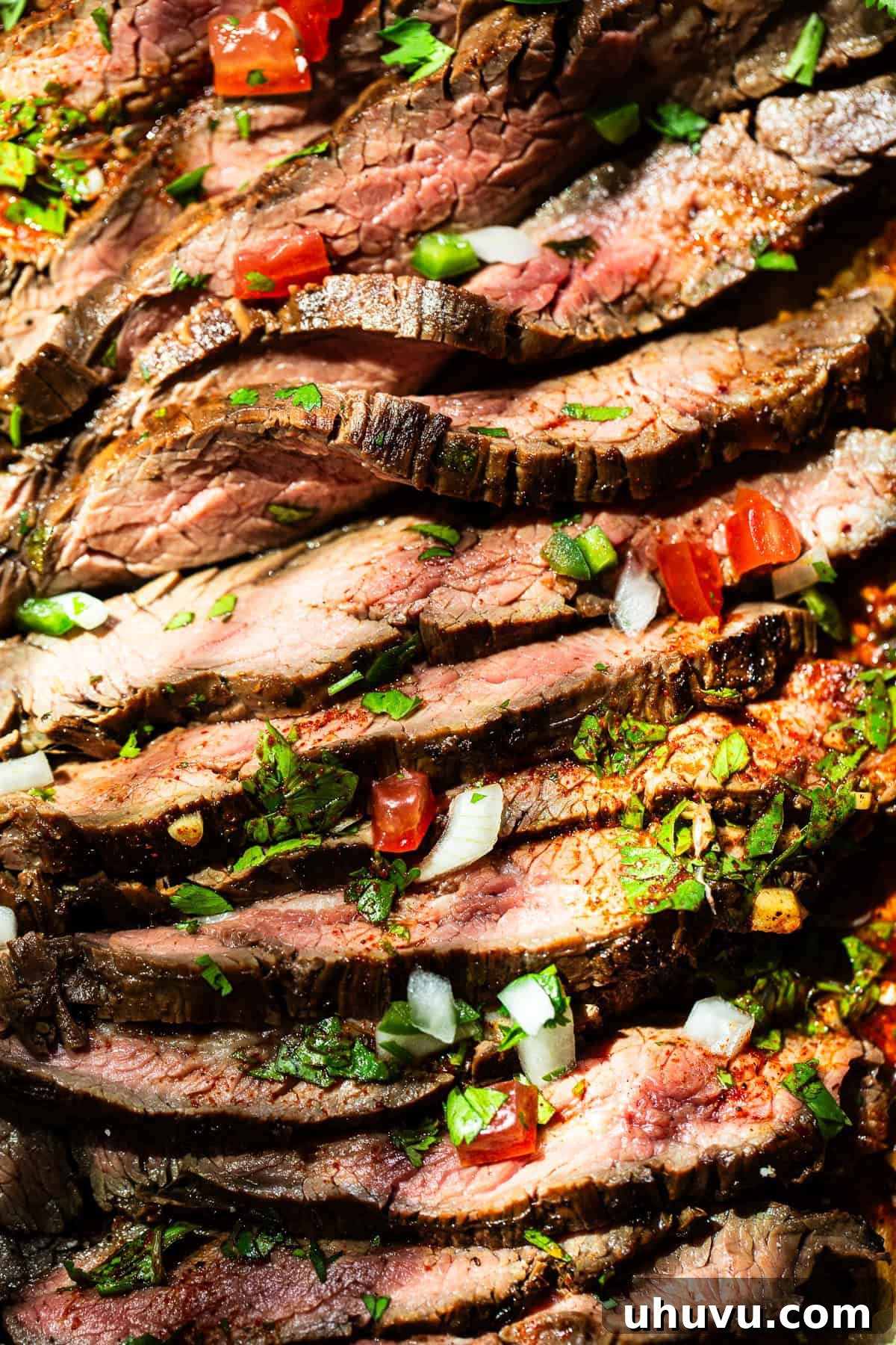 Perfect Grilled Carne Asada 8 A very close up shot of thinly sliced carne asada with the meat juices running out of it.