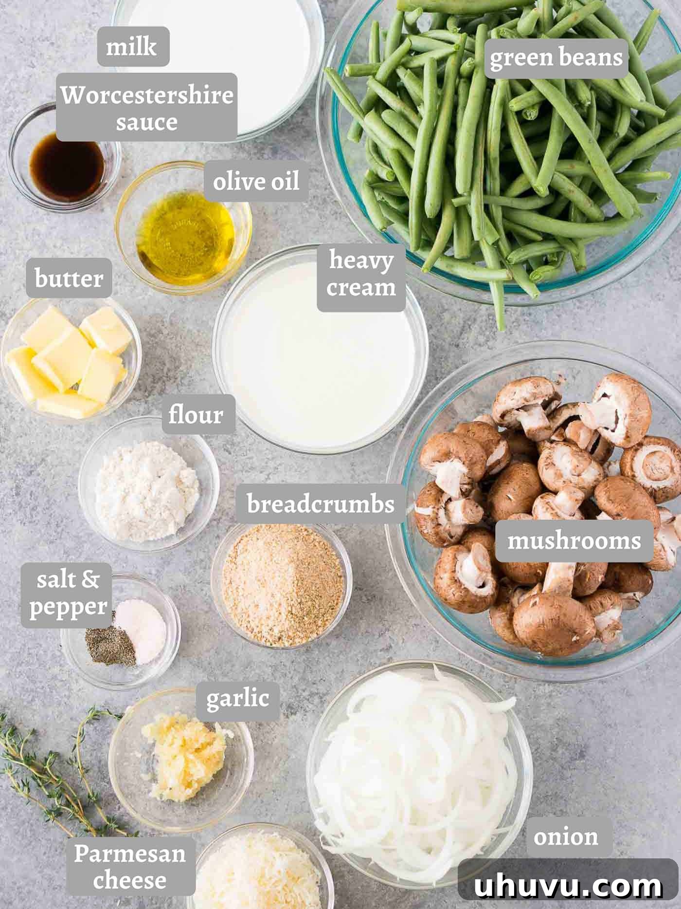 A flat lay image displaying all the fresh ingredients needed for a homemade green bean casserole, including green beans, mushrooms, onions, butter, and seasonings.