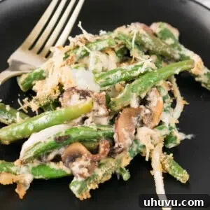 A beautiful serving of homemade green bean casserole on a plate, ready to be enjoyed.