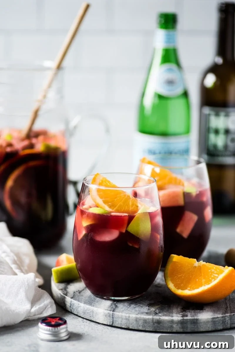 A delightful glass of red sangria, elegantly prepared with red wine and various fruits, ready to be savored.