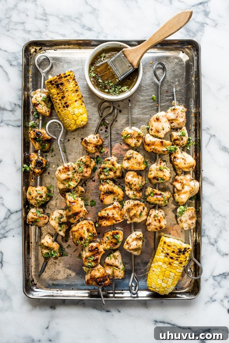 Succulent Chicken Kabobs Recipe 2 Freshly grilled chicken kabobs on skewers, ready to be served.