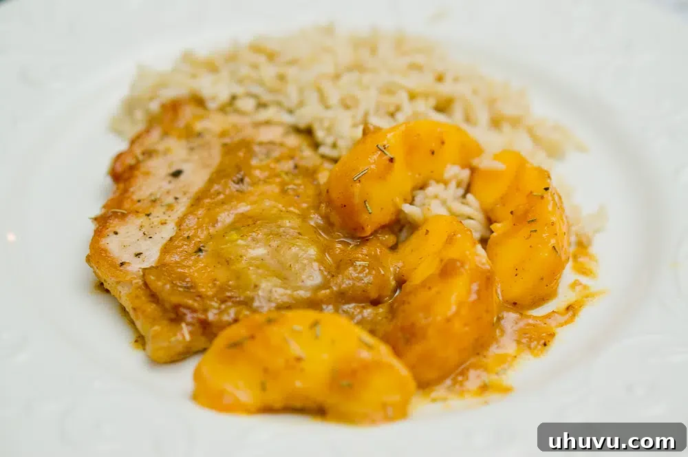 Plated Rosemary Peach Pork Tenderloin with the delicious sauce