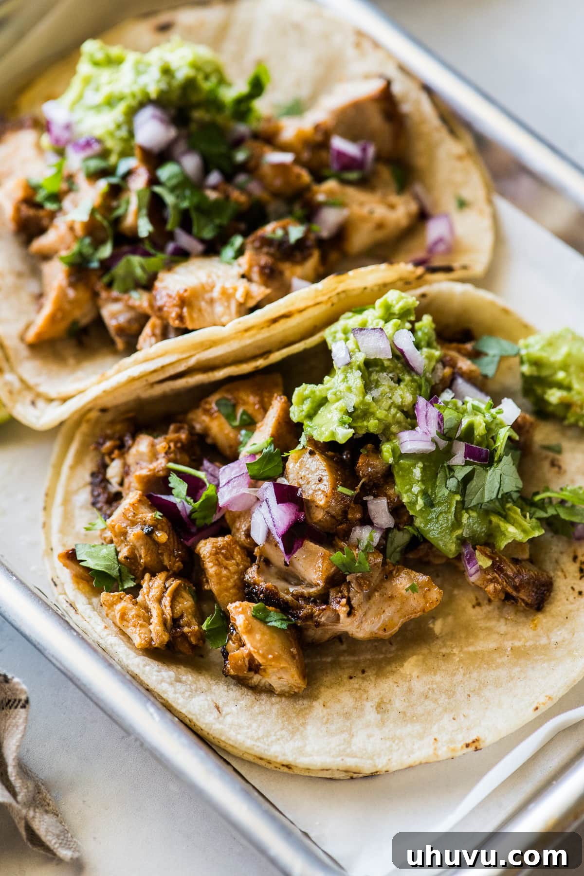 No-Fuss Chicken Tacos 5 The best chicken tacos recipe on warm corn tortillas topped with creamy avocado, crisp red onion, fresh cilantro, and a squeeze of lime.