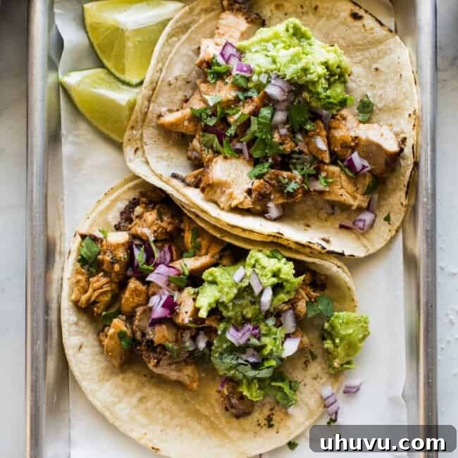 Easy chicken tacos recipe made with tender and juicy diced chicken and topped with avocado, onions, and lime juice.