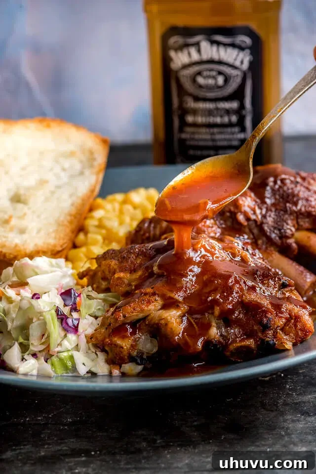 Plate of perfectly cooked whiskey glazed BBQ ribs, tender and succulent