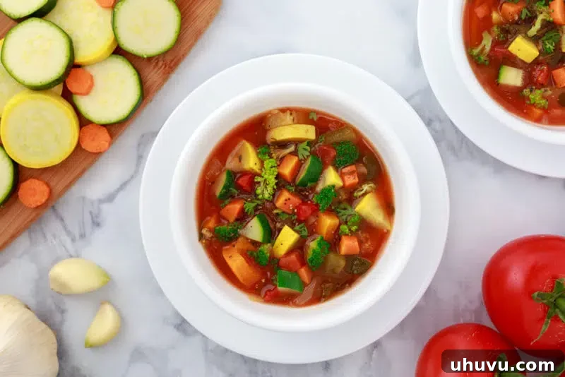 White bowl of vibrant weight loss vegetable soup made in an Instant Pot