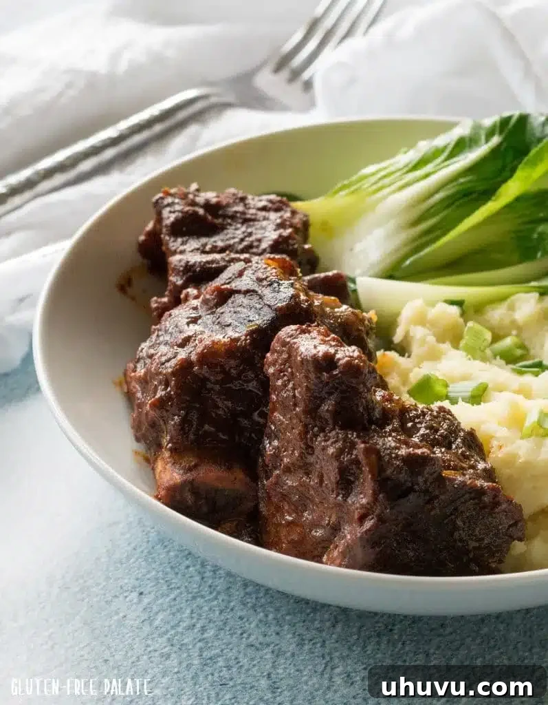 Easy Instant Pot beef short ribs served on a plate with creamy mashed potatoes