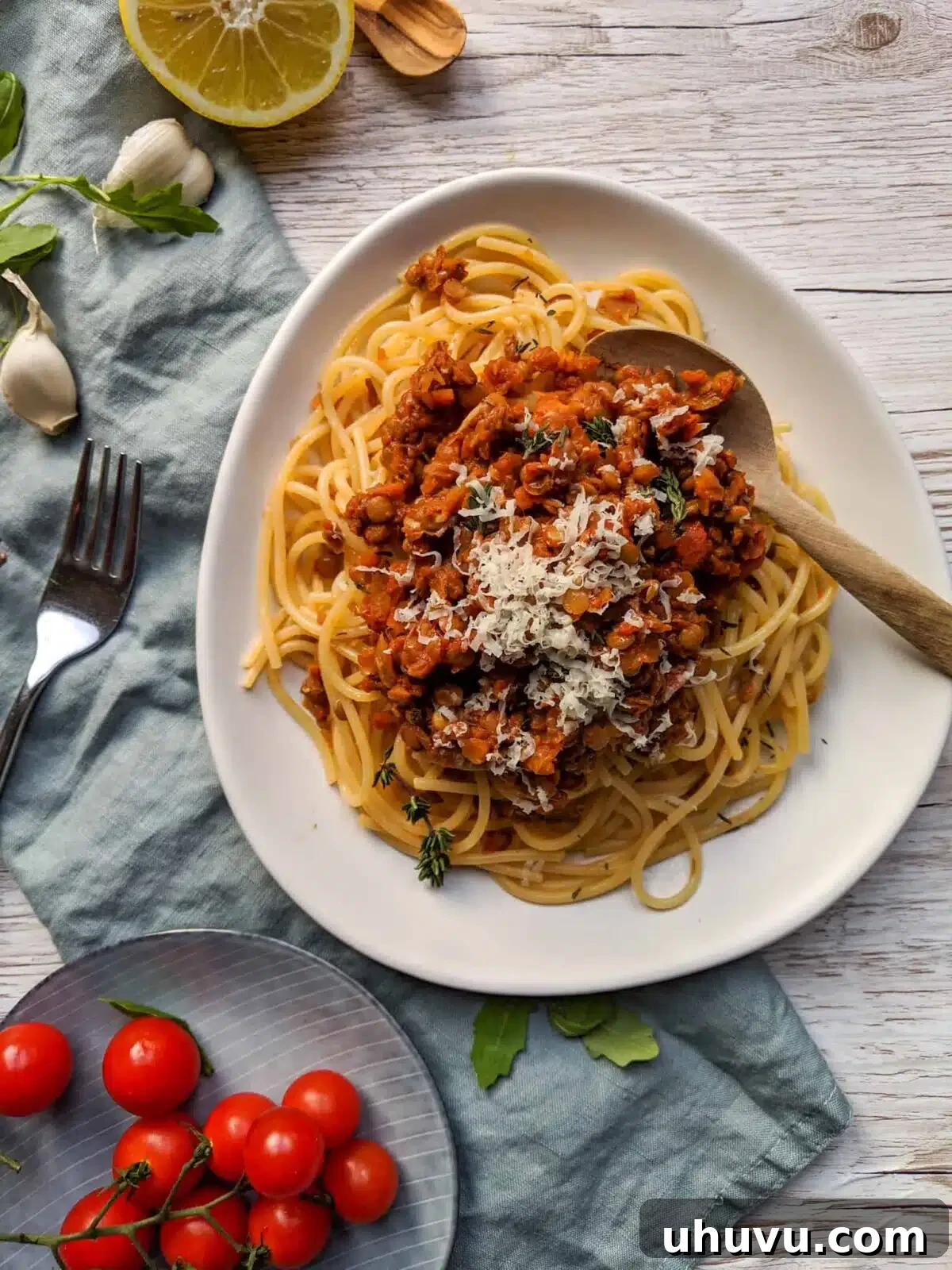 Lentil Spaghetti Bolognese - Meal Prep, garnished with fresh basil