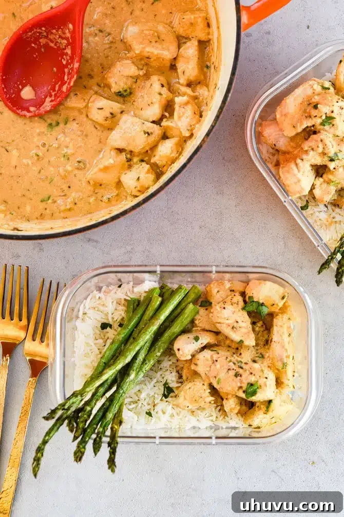 Dijon Thyme Chicken Tenders with rice and asparagus in a meal prep container, ready to eat