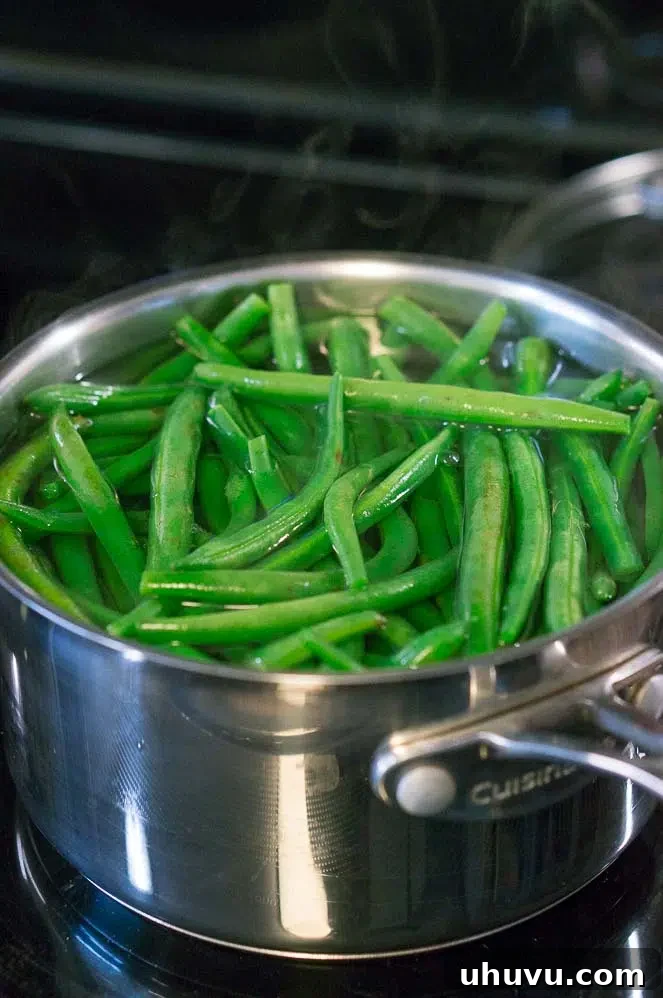 Fresh green beans being blanched in boiling water