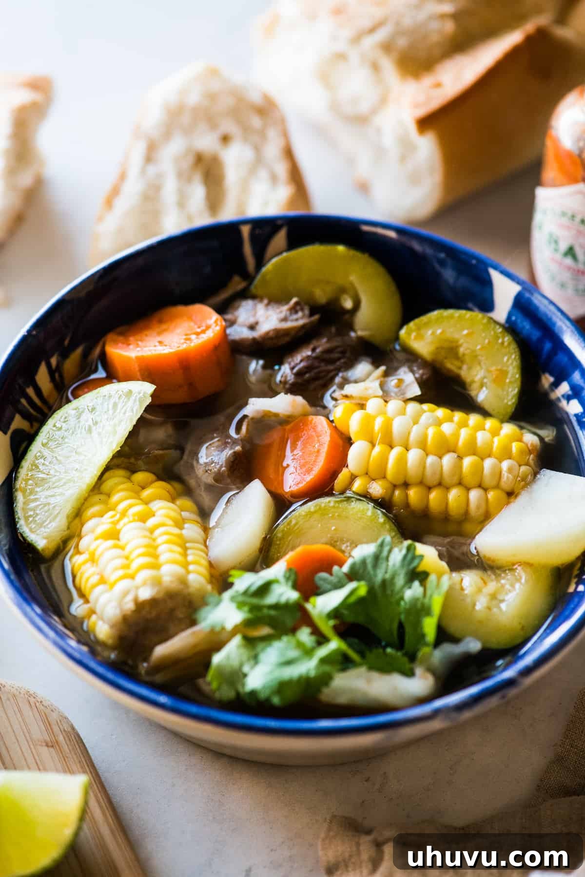 Heartwarming Beef and Vegetable Soup 9 A large bowl of Caldo de Res filled with chunks of carrot, zucchini, potatoes, corn, and tender beef, garnished with cilantro.