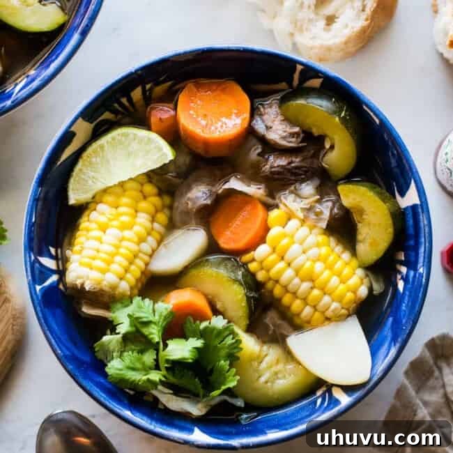 A close-up of a rustic bowl of Caldo de Res, showcasing the rich broth and hearty ingredients.