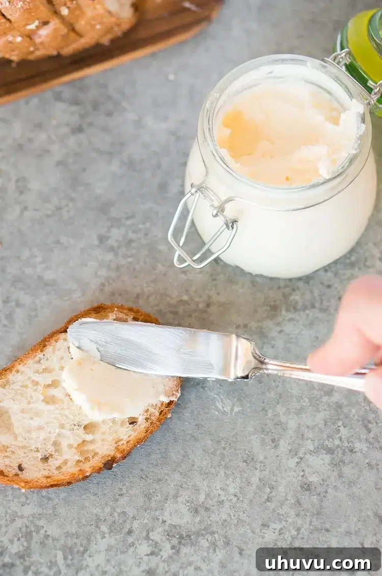 Spreading fresh homemade butter on a slice of bread