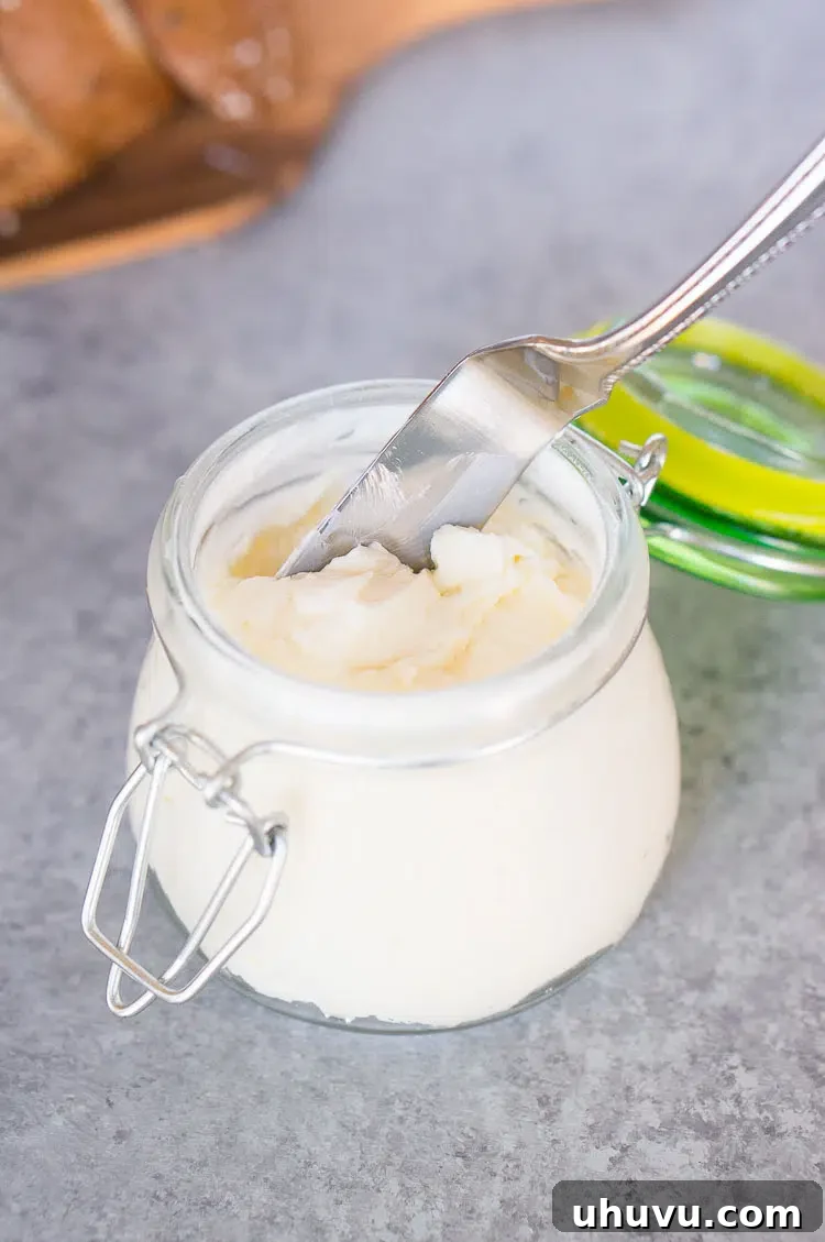 A knife stuck into a block of homemade butter