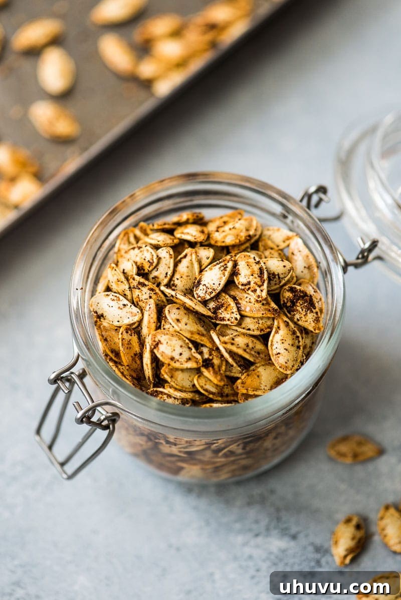 Crispy Roasted Pumpkin Seeds Made Easy 7 Roasted pumpkin seeds stored in a clear glass jar, perfect for keeping fresh and ready to snack.