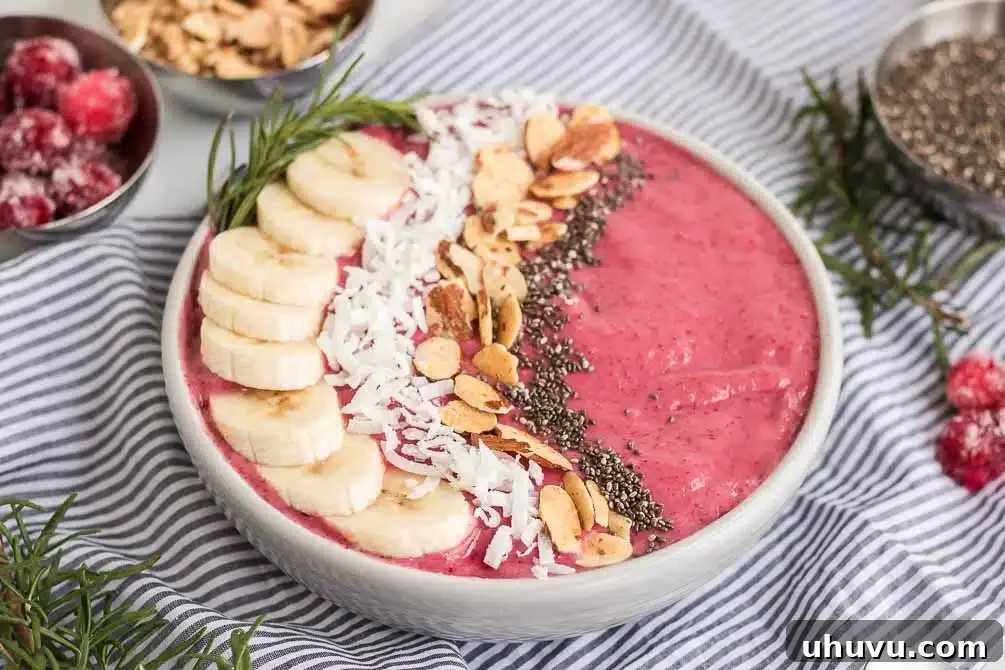 Cranberry smoothie bowl generously topped with various garnishes
