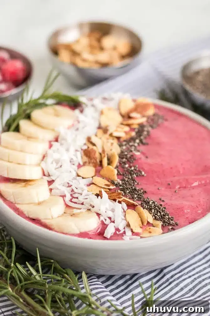 Cranberry banana yogurt smoothie bowl with a spoon