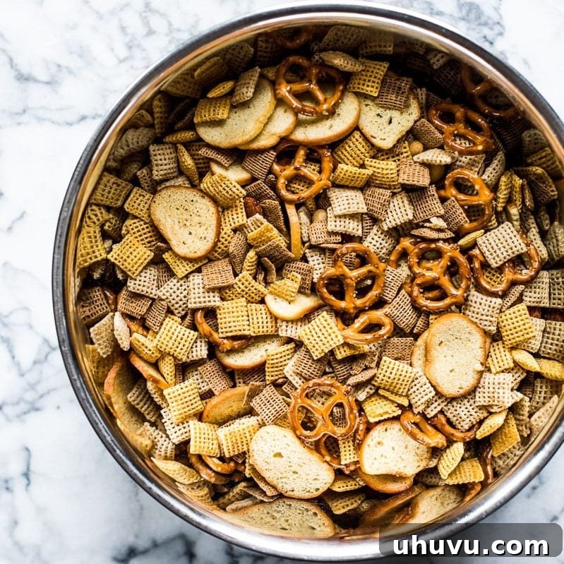 Addictive Fiery Chex Mix 3 A close-up of the homemade Spicy Chex Mix, showcasing its rich coating and variety of crunchy ingredients.
