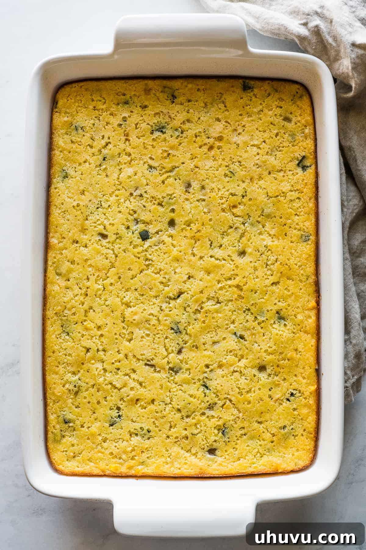 Zesty Green Chili Corn Bake 7 A selection of holiday side dishes including green chili corn casserole, green bean casserole, and Brussels sprouts, arranged beautifully on a table for a festive meal.