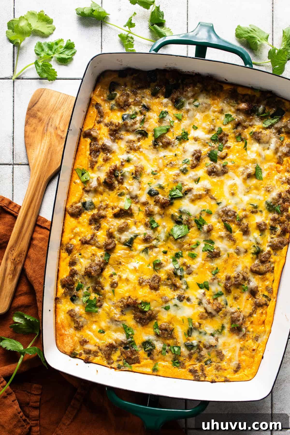 Golden Crescent Morning Bake 2 A golden brown crescent roll breakfast casserole in a large baking dish, topped with fresh cilantro, ready to be served.