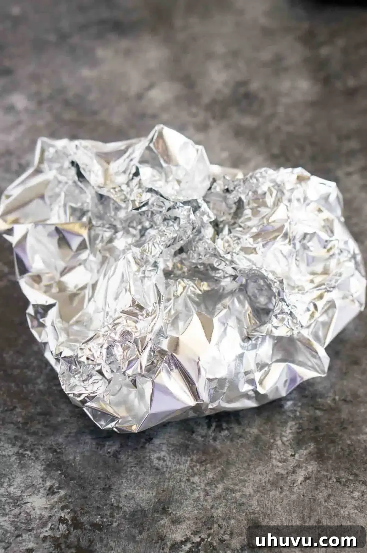 Garlic wrapped in aluminum foil, ready for the oven