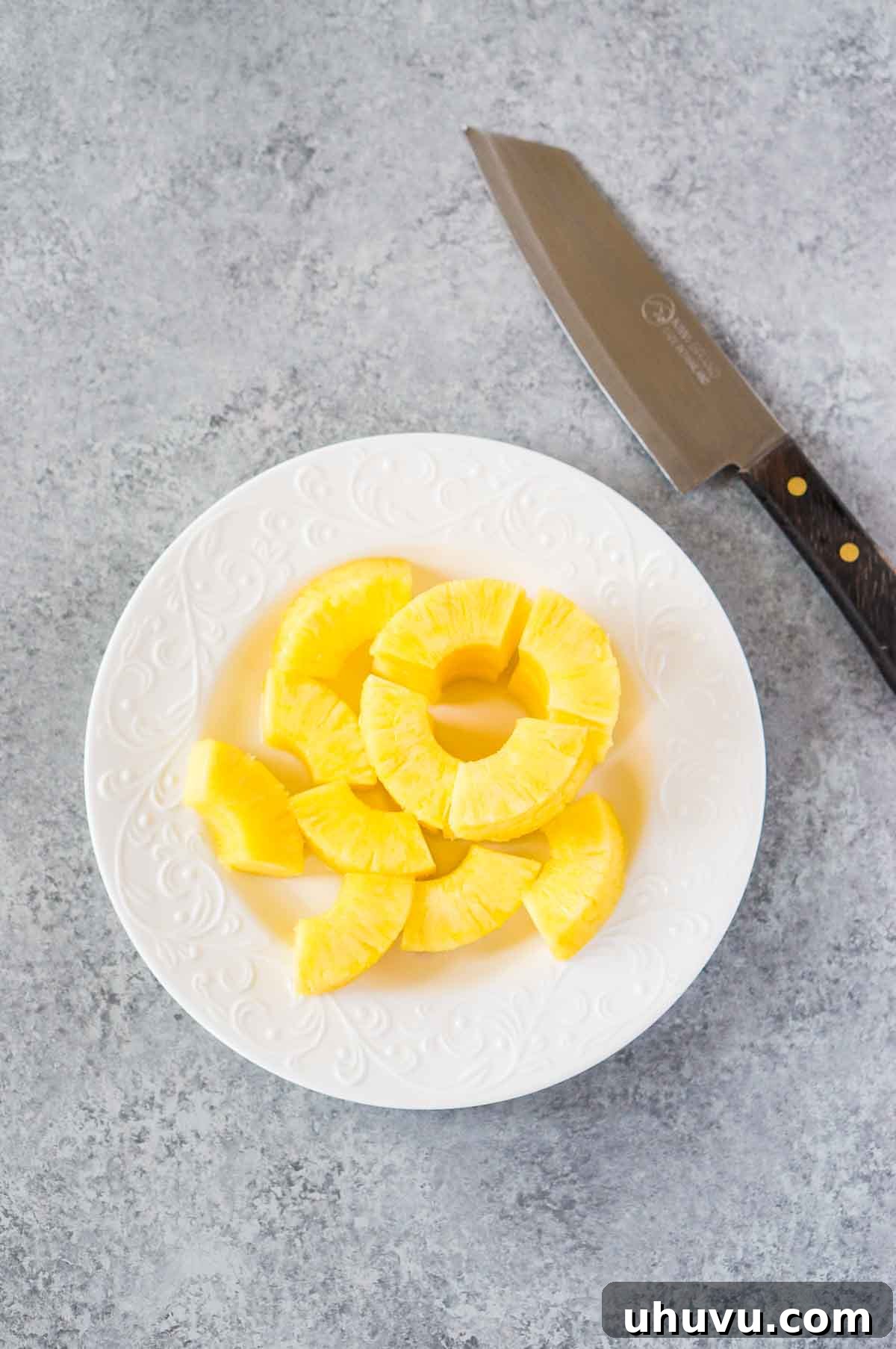 Sweet & Savory Bacon Pineapple Poppers 4 Fresh pineapple chunks prepared on a plate for bacon wrapping