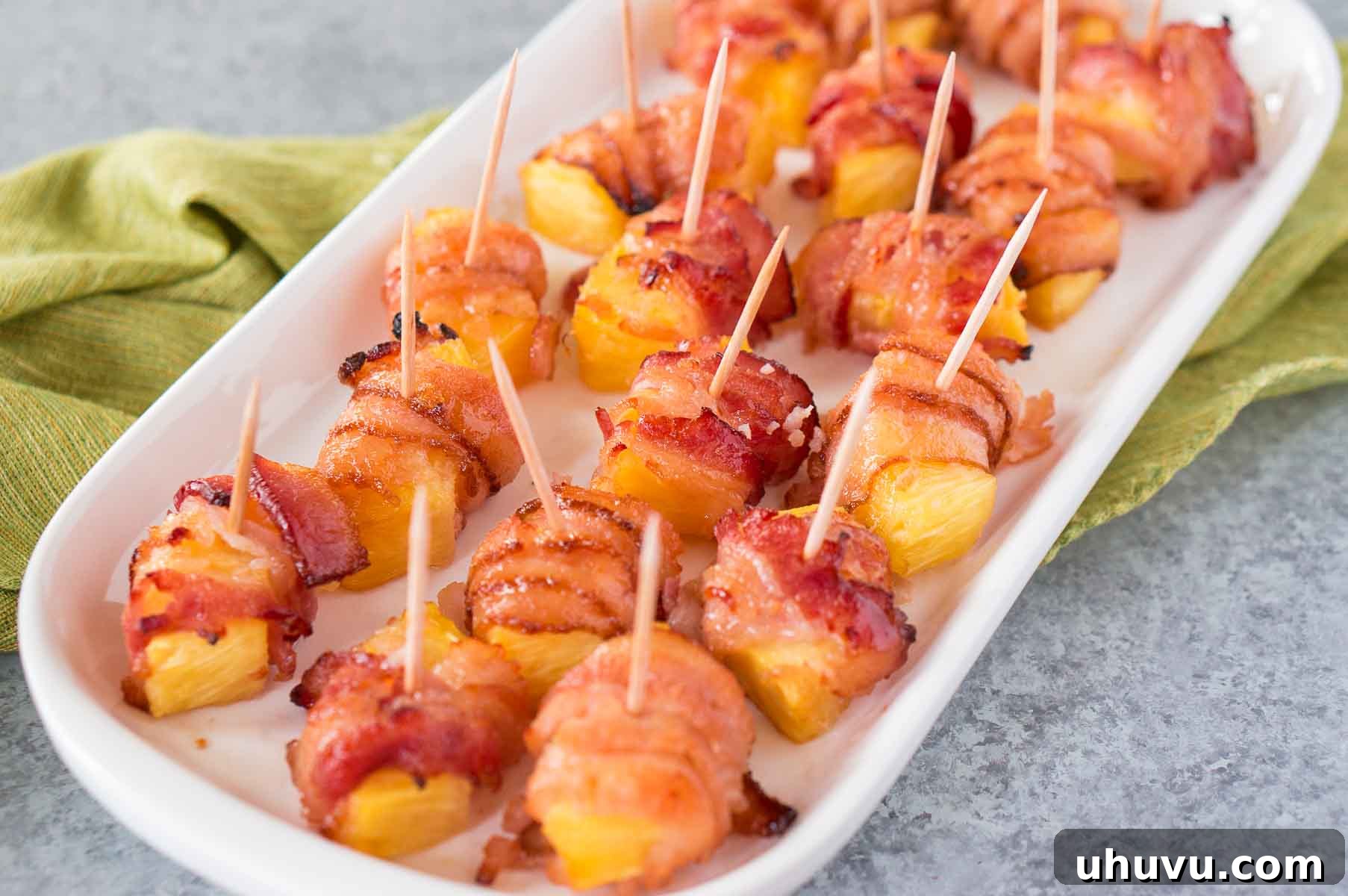 Sweet & Savory Bacon Pineapple Poppers 7 Close-up of baked bacon wrapped pineapple bites ready to serve